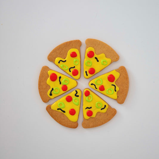 Six dog-friendly treats from Macs Munchies, shaped like pizza slices arranged in a circle, topped with K9-safe cheese icing, pepperoni circles, vegetable circles, and olive squiggles—create the perfect Pizza Pizza! delight.